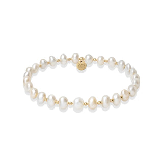 A delicate pearl bracelet with small white freshwater pearls and gold spacer beads, featuring a gold clasp engraved with the brand name 'baro'.