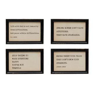 A wood framed wall decor piece with assorted text-based quotes in black frames.