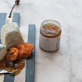 A photo of an open jar of the peach bourbon cardamom fruit preserves 