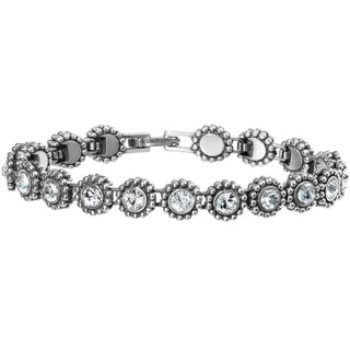 A bracelet featuring a series of connected round charms, each with a central twinkle, set in a silver-colored metal. Brighton Twinkle Link Bracelet