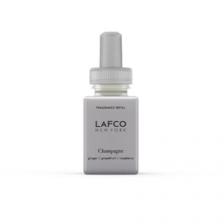 A Pura refill l that reads 'LAFCO NEW YORK' and 'Champagne' with additional text indicating fragrance notes: 'ginger, grapefruit, raspberry'. It is a fragrance refill for a smart diffuser.