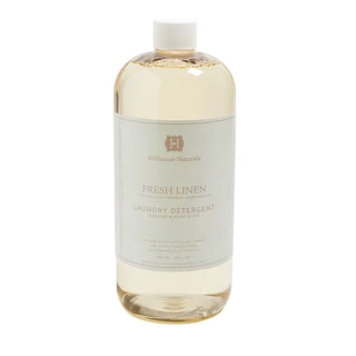 A clear bottle of Hillhouse Naturals Fresh Linen Laundry Detergent, machine and hand wash