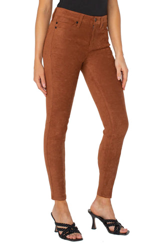 A model wearing Liverpool skinny, suede pants in a chestnut color.
