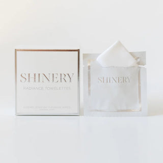 A box and packet of Shinery Radiance Jewelry Wipes with the brand name visible, designed for cleaning jewelry.