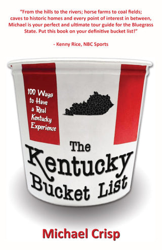 The image shows the cover of a book titled 'The Kentucky Bucket List' by Michael Crisp. The cover design is predominantly white and red, featuring a silhouette of Kentucky and text detailing the book's title and subtitle, which is a bucket-shaped container with a lid.