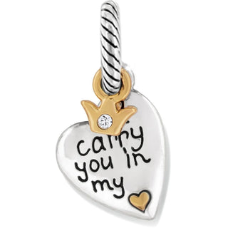 A silver heart-shaped charm with the inscription 'Carry You In My Heart' and a small gold-colored crown above it. Brighton Carry You Charm